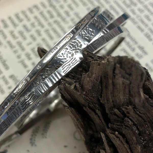 silver bangles with texture and tree bark