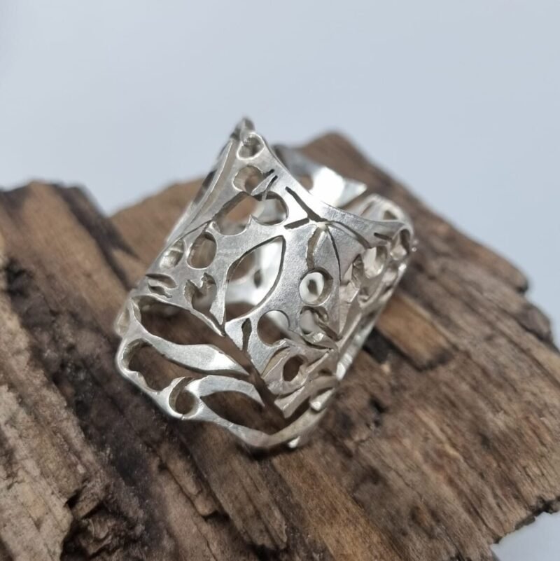 Silver ring with intricate saw pierced detail