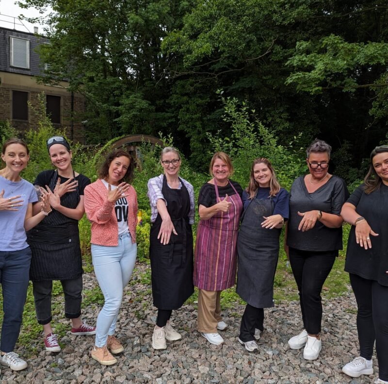 Happy faces wearing silver and copper rings made in the workshop
