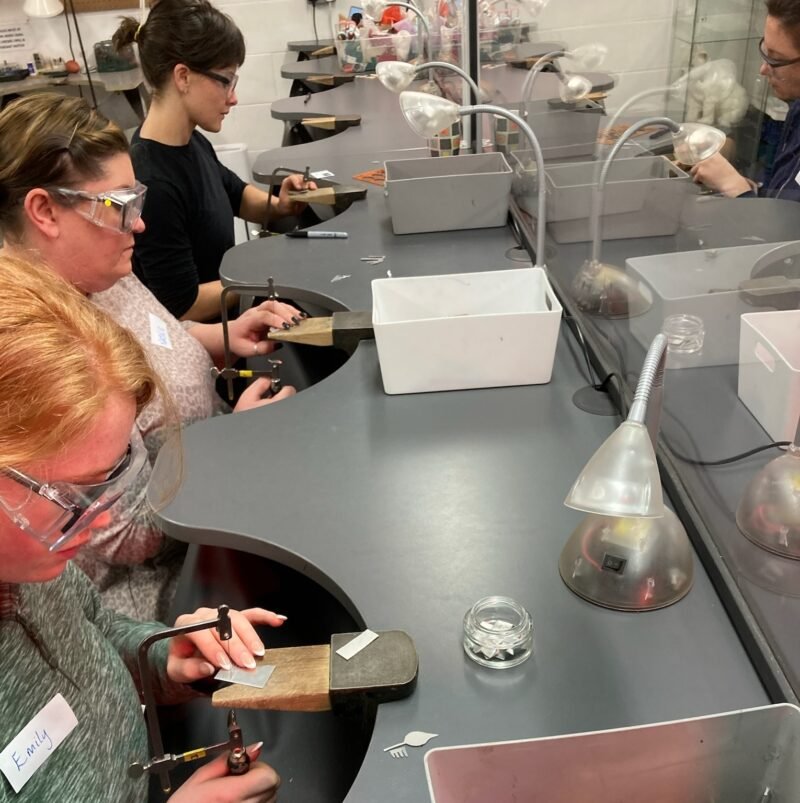 Students saw piercing at the workbenches