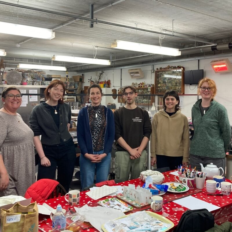 Happy smiling people at the end of a silver jewellery day