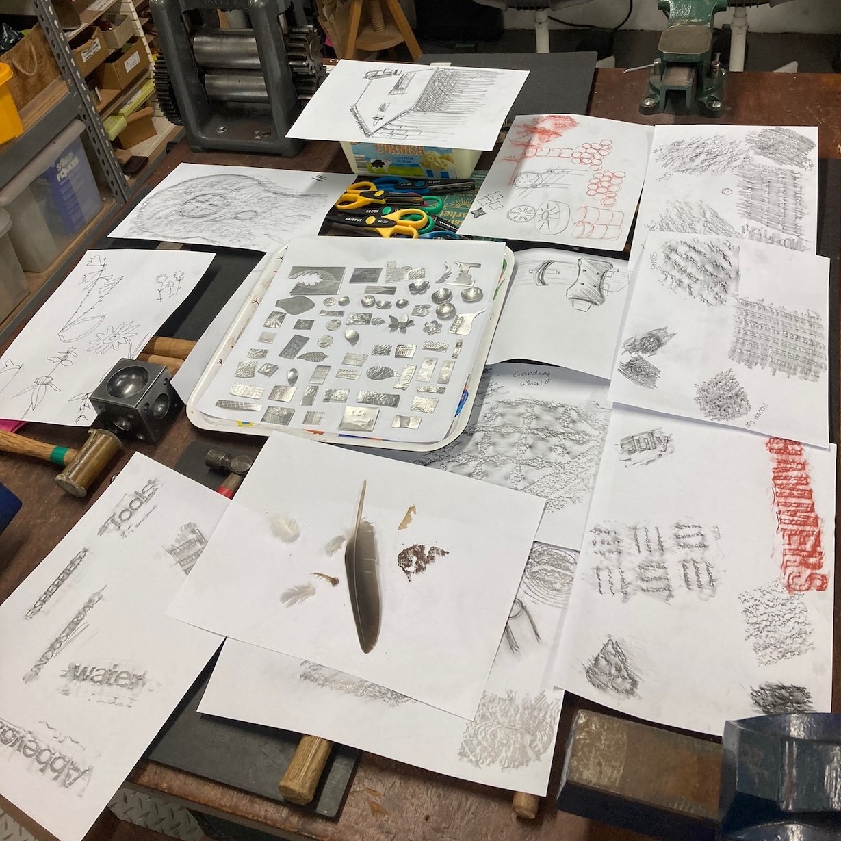 Drawings and rubbings laid out in the workshop
