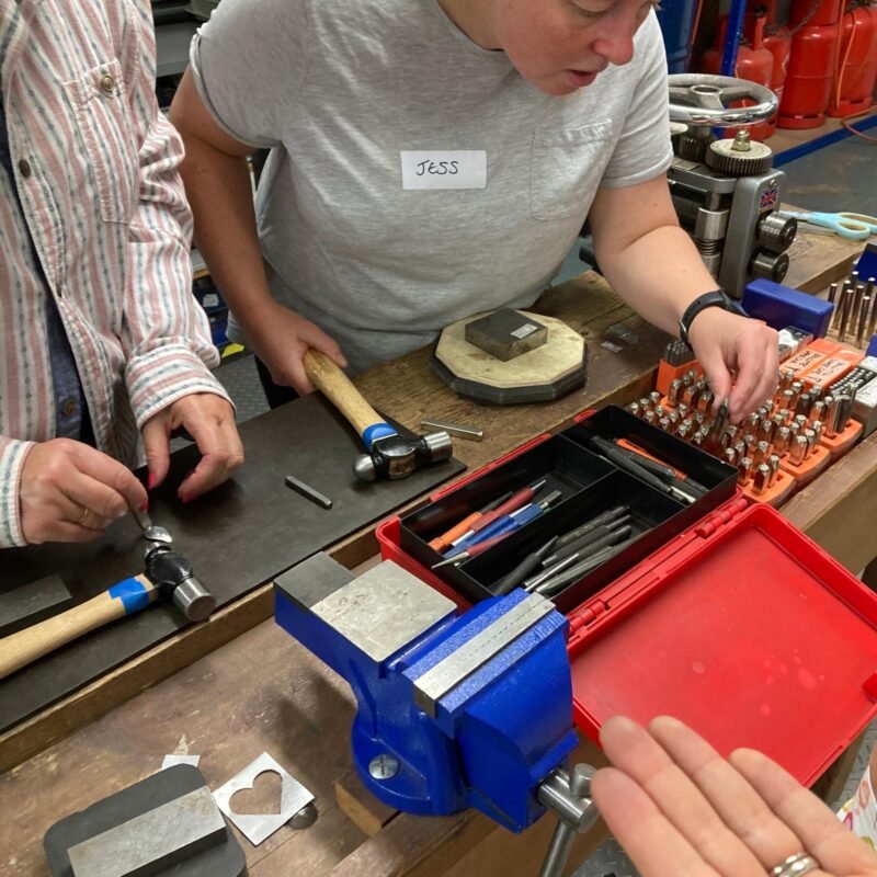 Students selecting punches for stamping onto metal