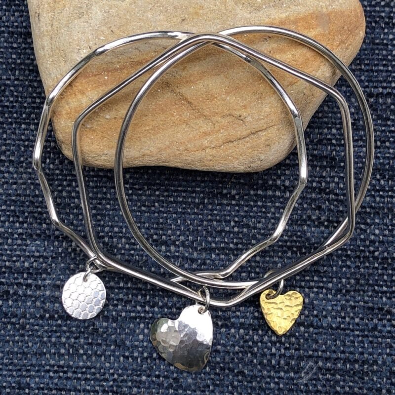 Silver bangles with silver and brass charms