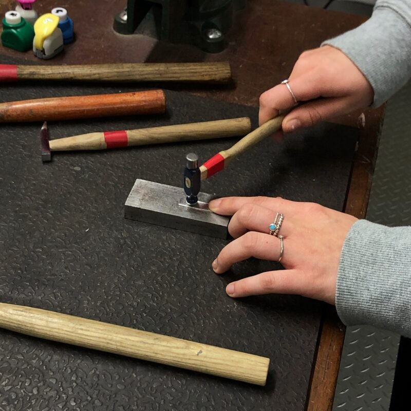 Student hammering at the workbench