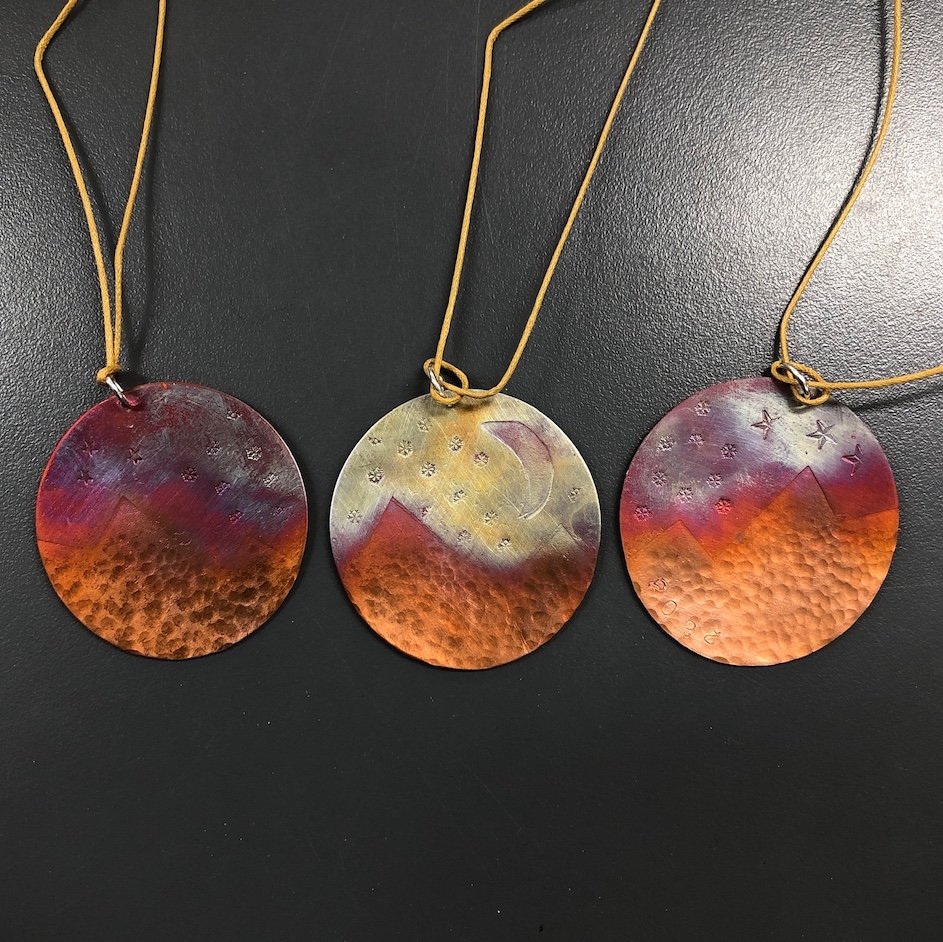 Colourful copper Christmas decorations with gold thread.